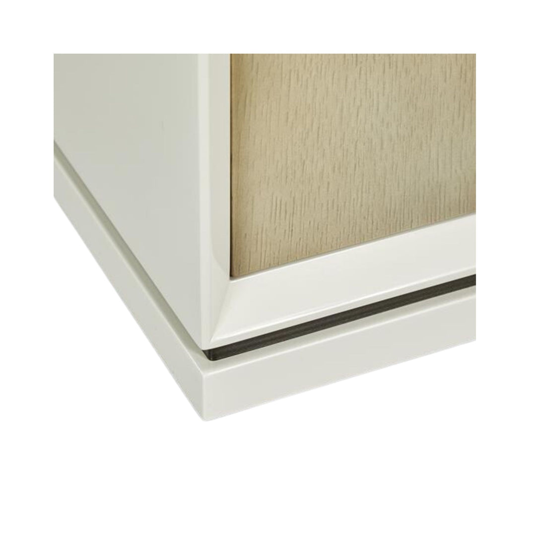 White lacquered bedside table with oak drawers and bronze handles