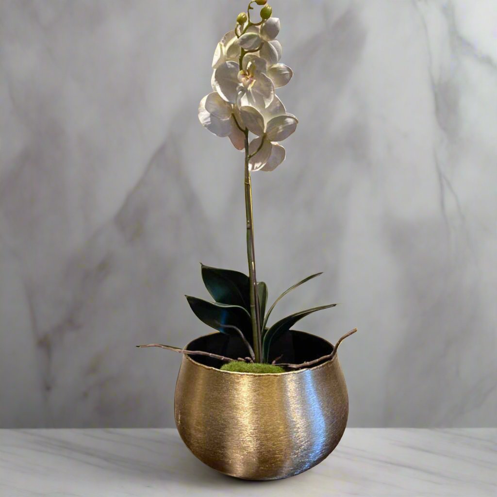 Small artificial orchid flower in a gold pot